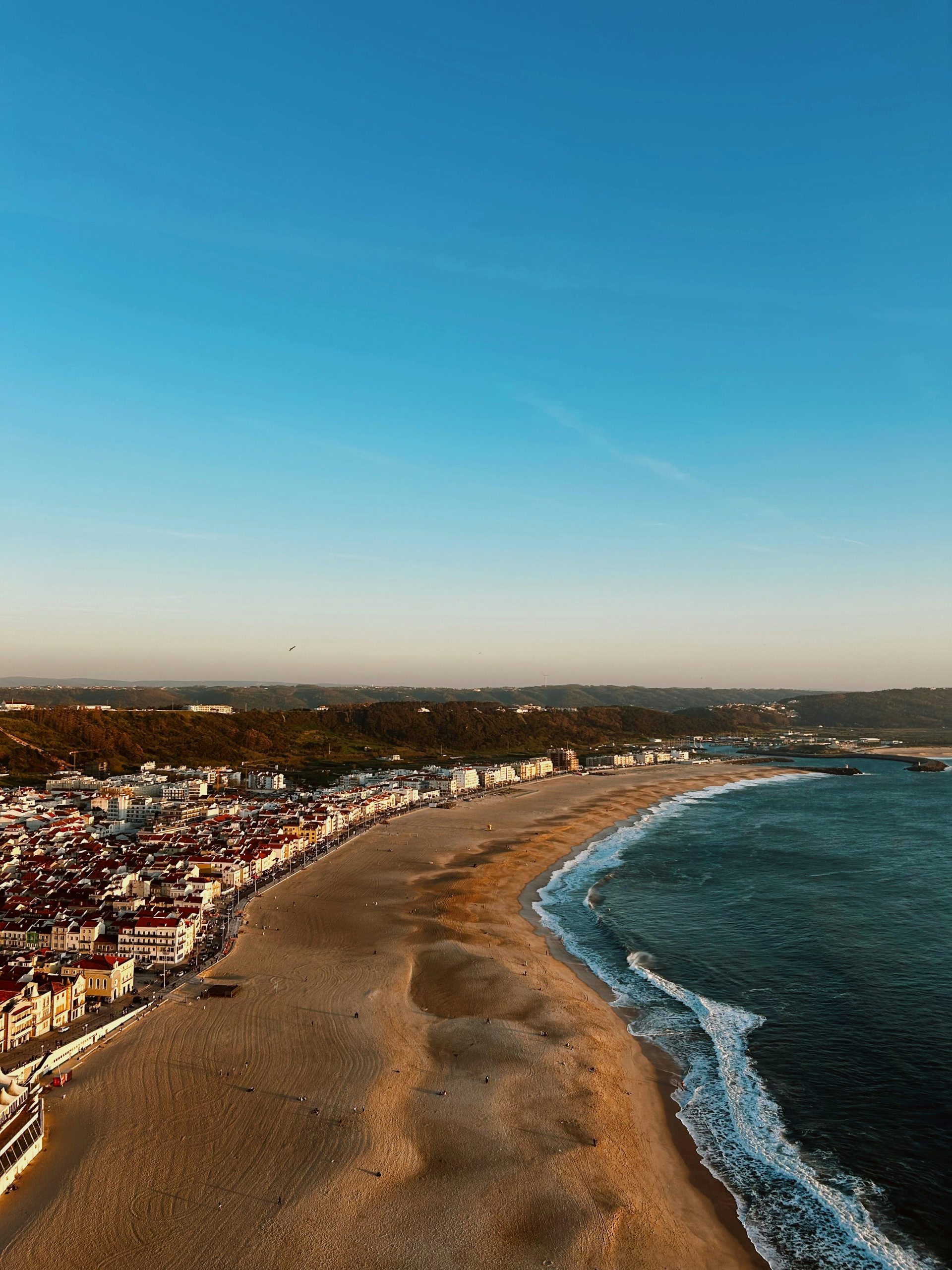 Coastal town with sandy beach and ocean waves